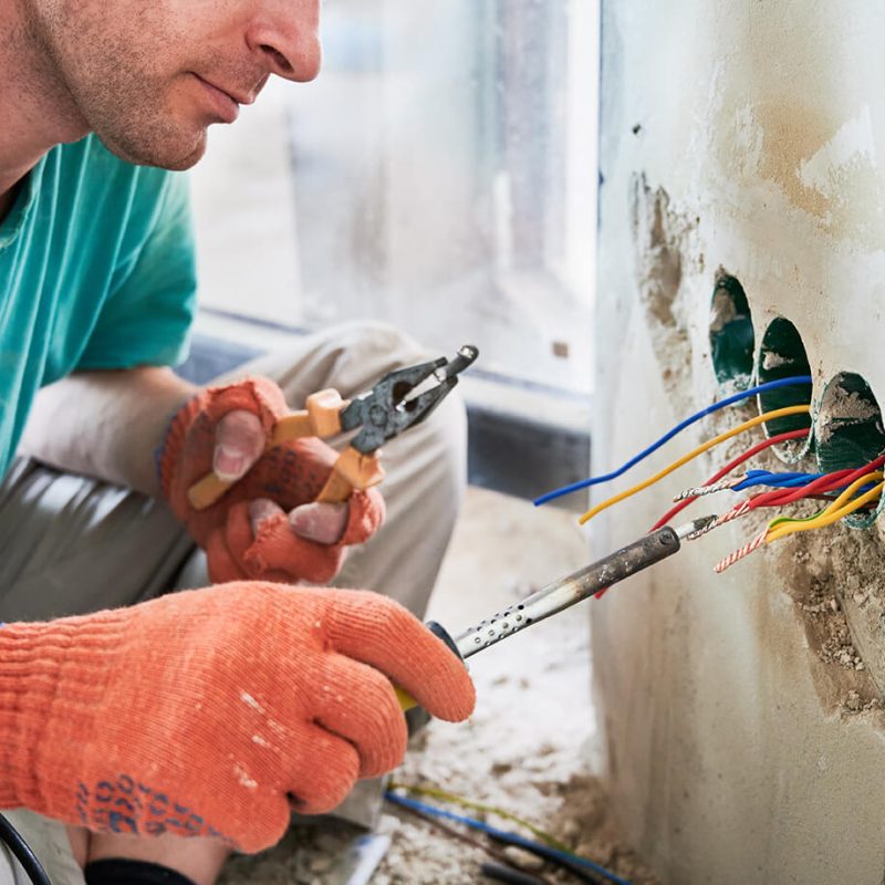 male-electrician-using-electric-soldering-iron-in-2023-02-16-01-29-12-utc